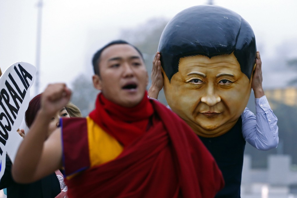 A protester wearing a giant head representing President Xi Jinping takes part in a demonstration at the UN in Geneva in October. Photo: Reuters