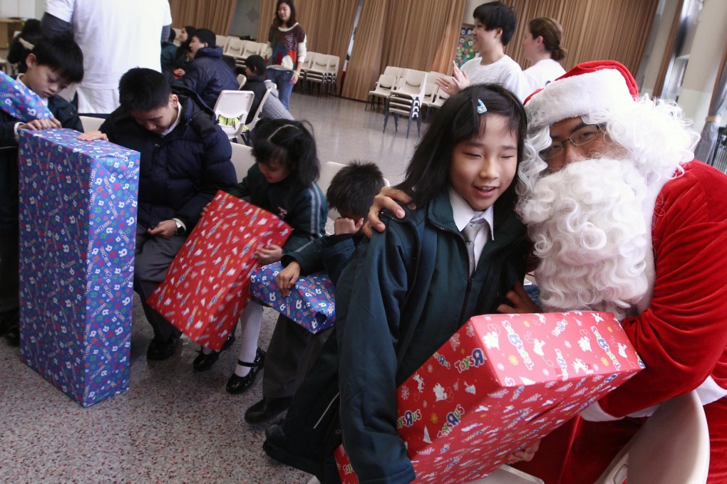 Delighted children at the Ebenezer School and Home for the Visually Impaired open their presents from Santa. Photo: Jonathan Wong