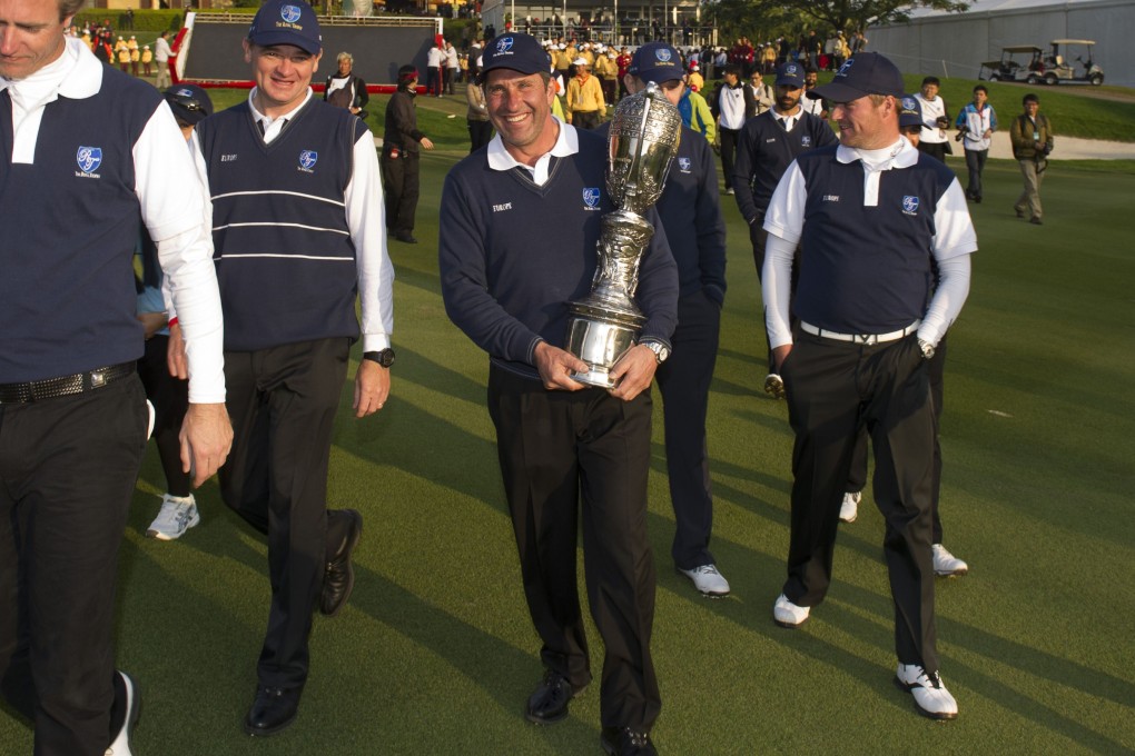 Europe captain Jose Maria Olazabal carries the Royal Trophy after his team clinched a narrow victory over Asia at Guangzhou's Dragon Lake Golf Club. Photo: AFP