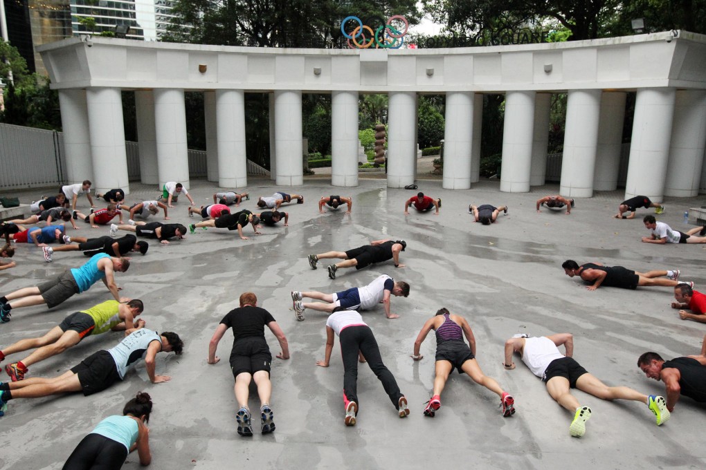 Press-ups test out participants in a fitness class in Hong Kong Park in Central .Photo: K.Y. Cheng