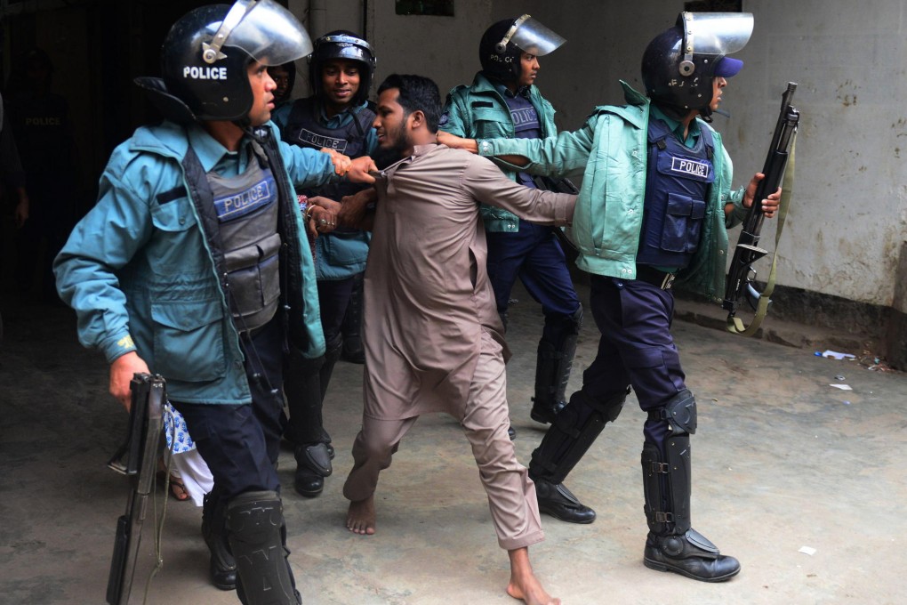 Police detain a suspected activist of Hizb-ut-Tahrir, which is a banned Islamist militant organisation, in Dhaka. Photo: AFP