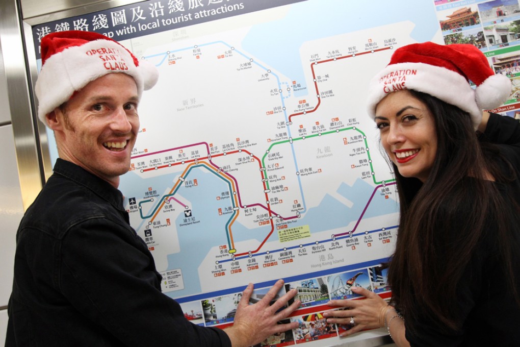 Tim Littlechild and Chantel Shafie poses at Central MTR Station as they will take on the challenge of travelling to all MTR stations in the shortest time to raise funds. Photo: David Wong