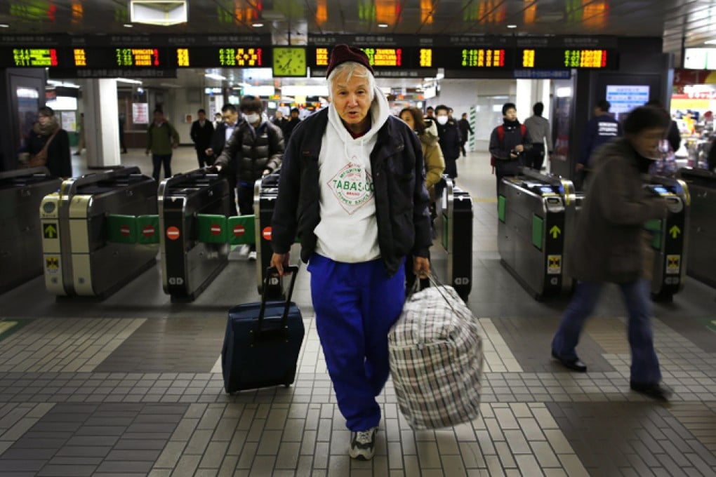 A homeless man arrives at Sendai Station, where recruiters are on the lookout for labourers to help the Fukushima clean-up. Photos: Reuters