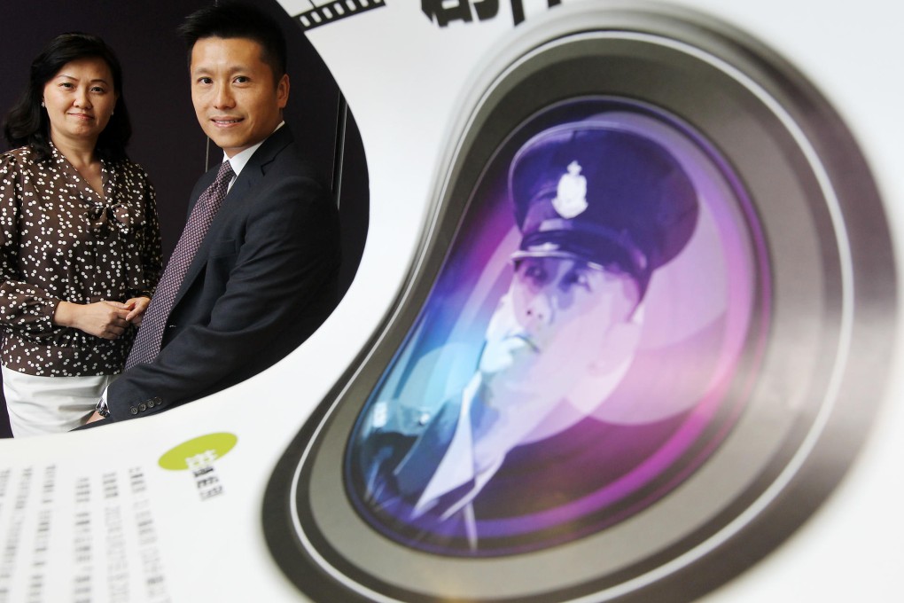 Yolanda Chan and John Tse, of the police's service quality wing, encourage officers to live up to the values of the force, such as responsibility and accountability. Photo: Sam Tsang