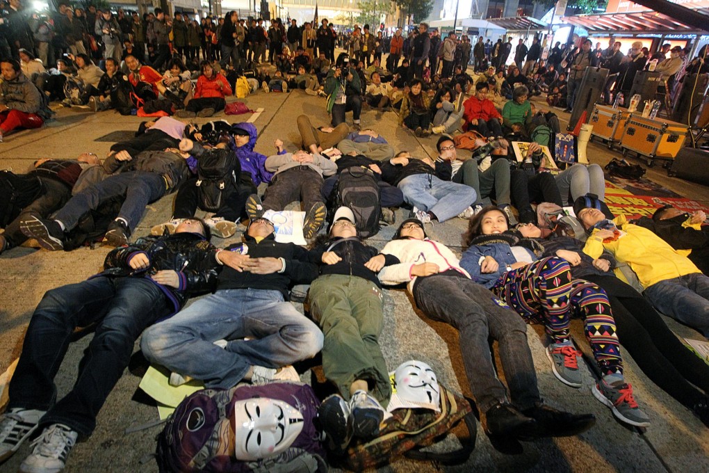 Marchers lie down in Chater Road in 'practice' for Occupy Central's planned acts of civil disobedience in the summer. Photo: Sam Tsang