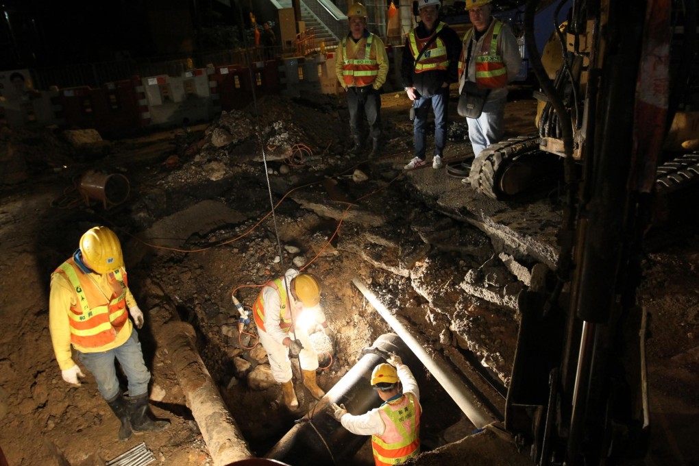 Workers repair the damaged water pipes. Photo: Edward Wong