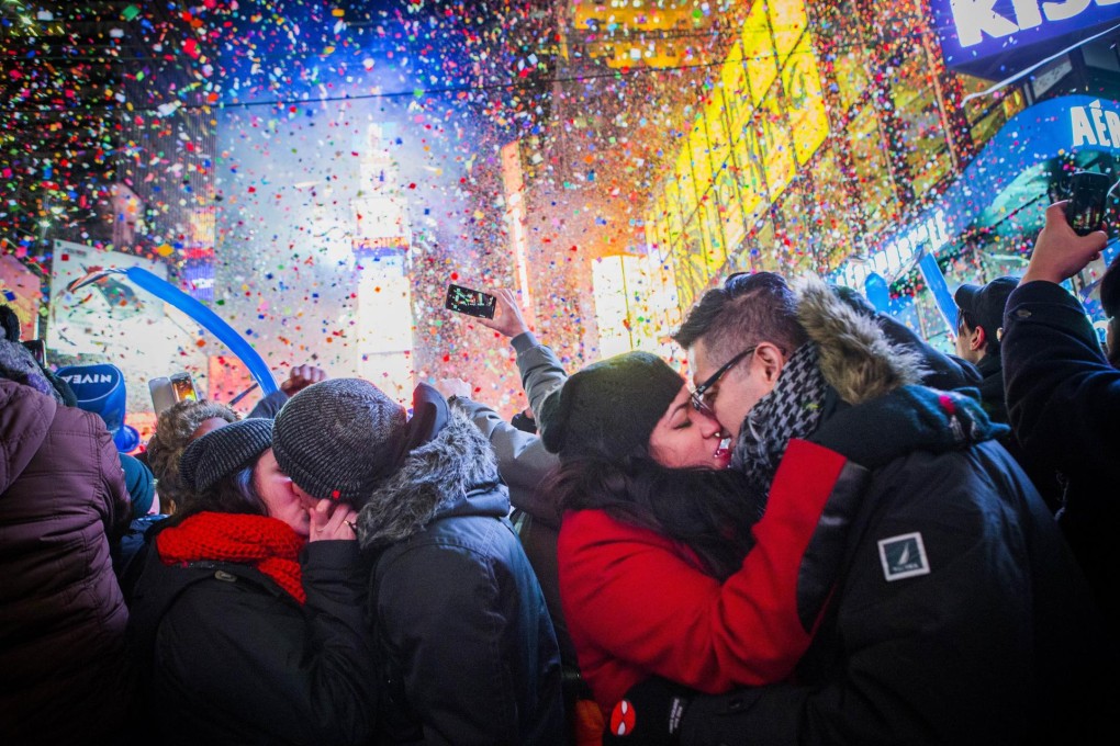 Couples kiss and celebrate the new year after midnight in New York's Times Square. Photo: AFP