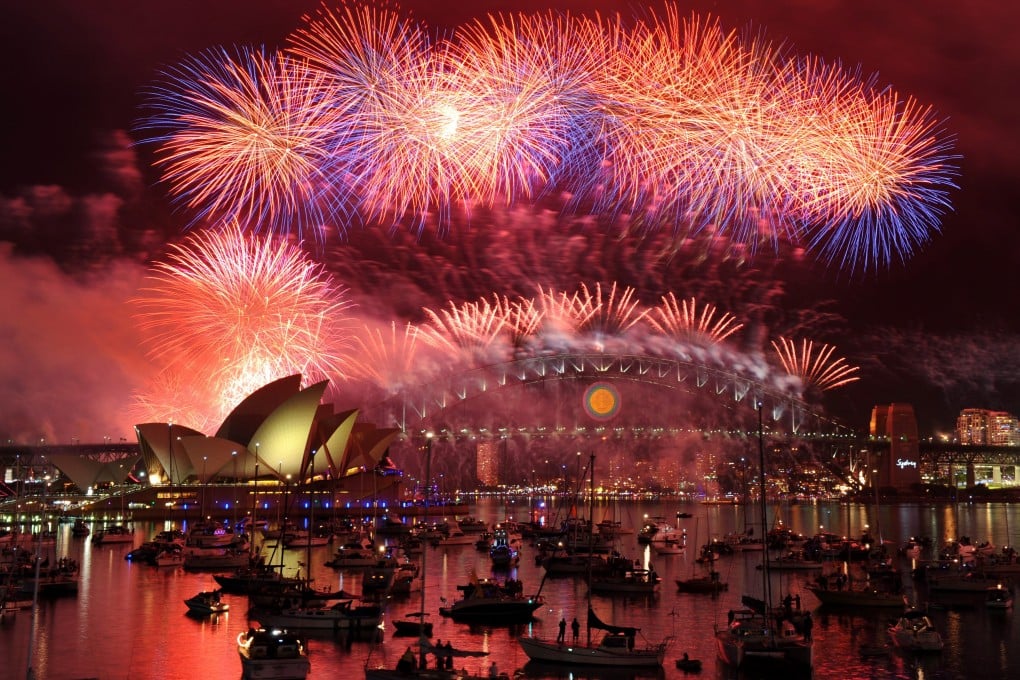 Exploding fireworks spray from the sails of the Sydney Opera House and the Australian city's harbour bridge last night as the world ushered in a new year. Photo: EPA