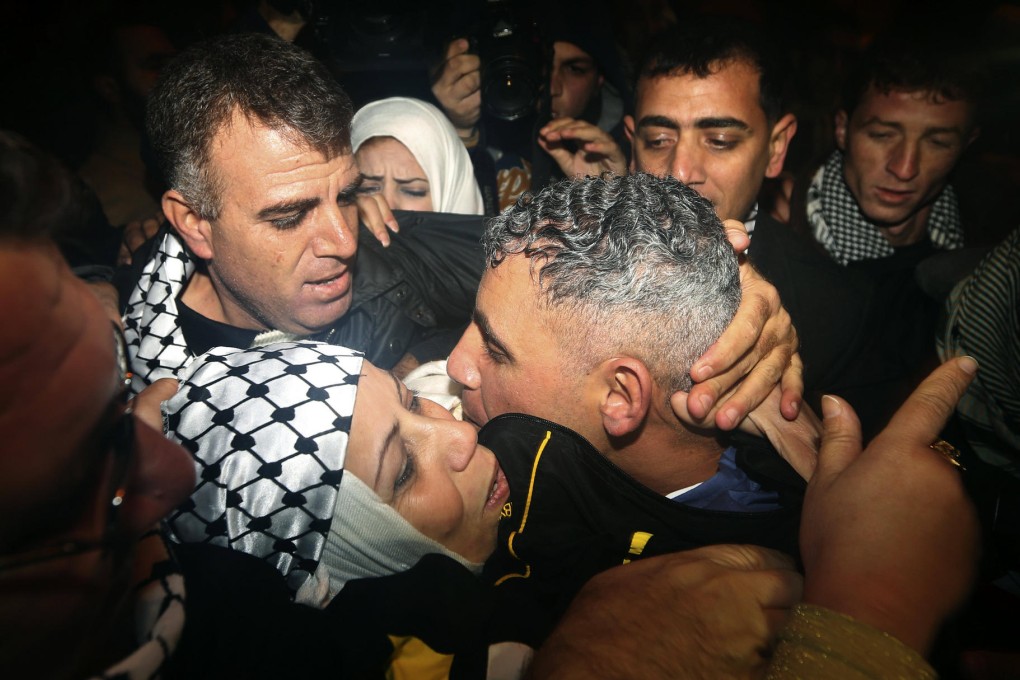 A released Palestinian prisoner (centre) is reunited with his mother after arriving at a checkpoint in the north of the Gaza Strip. Photo: AP