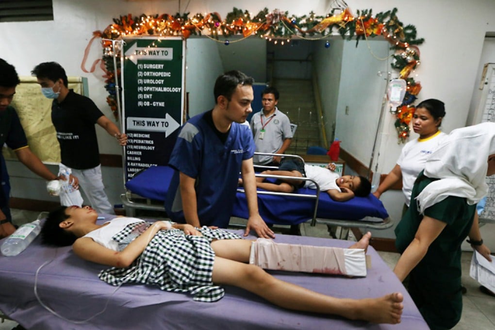 Filipino children injured from a firework accident are rushed to a government hospital during celebration of New Year in Manila, Philippines. Photo: EPA