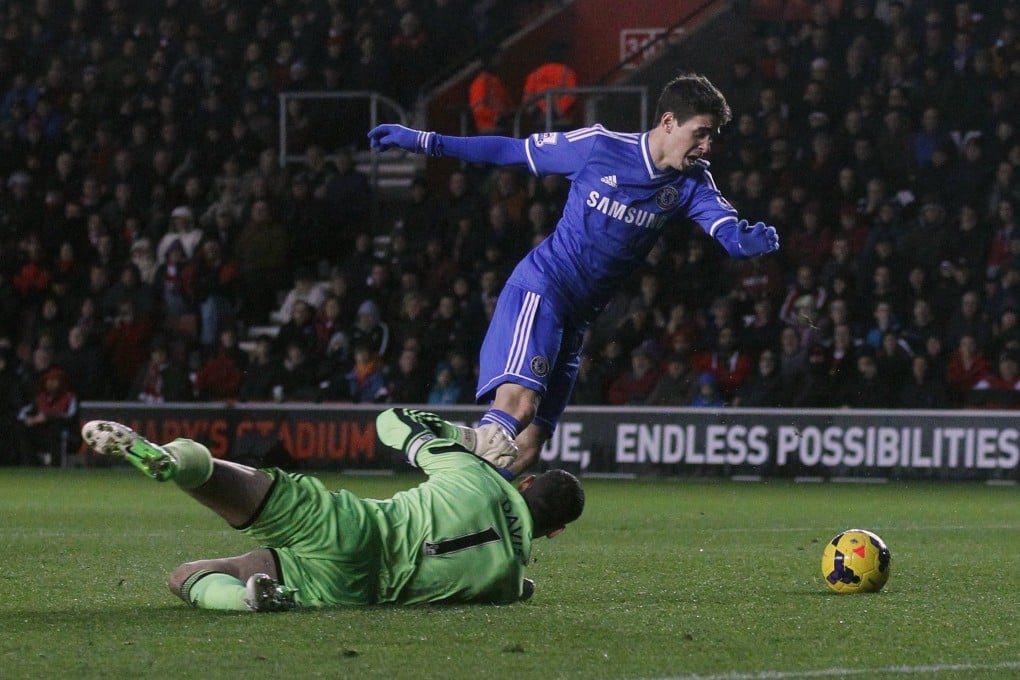 Chelsea's Oscar takes a tumble in front of Southampton goalkeeper Kelvin Davis. Photo: AP