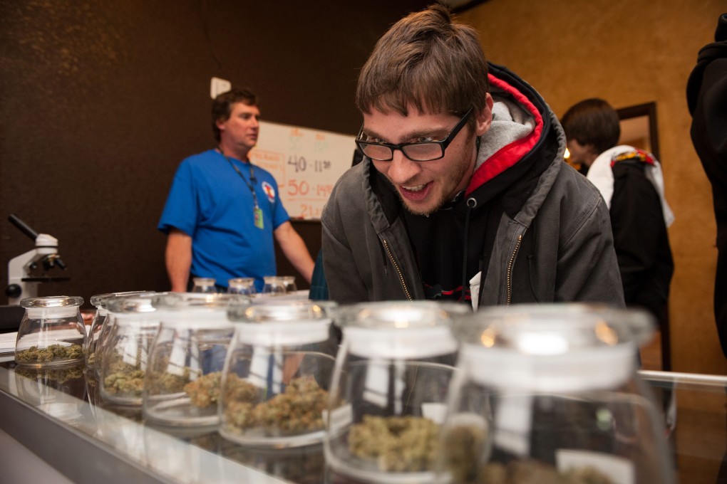 A customer selects marijuana strains to purchase at the 3-D Denver Discrete Dispensary. Photo: AFP
