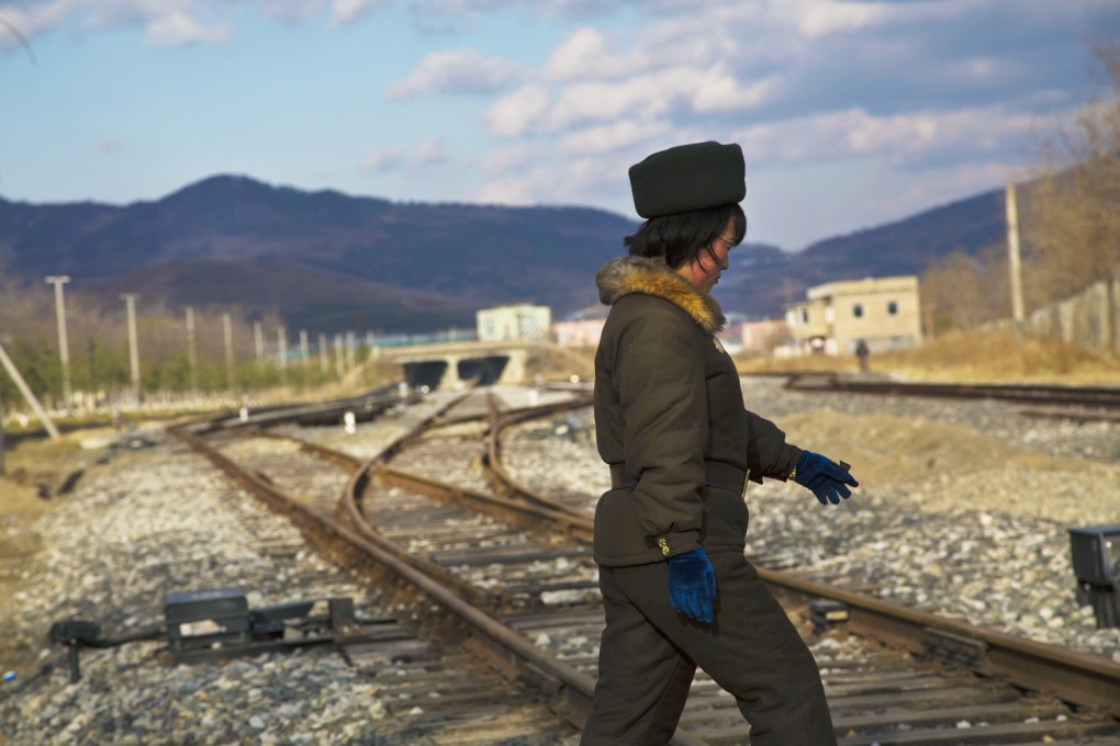 A North Korean soldier walks across a newly opened train track linking to the Rason special economic zone. Photo: AP