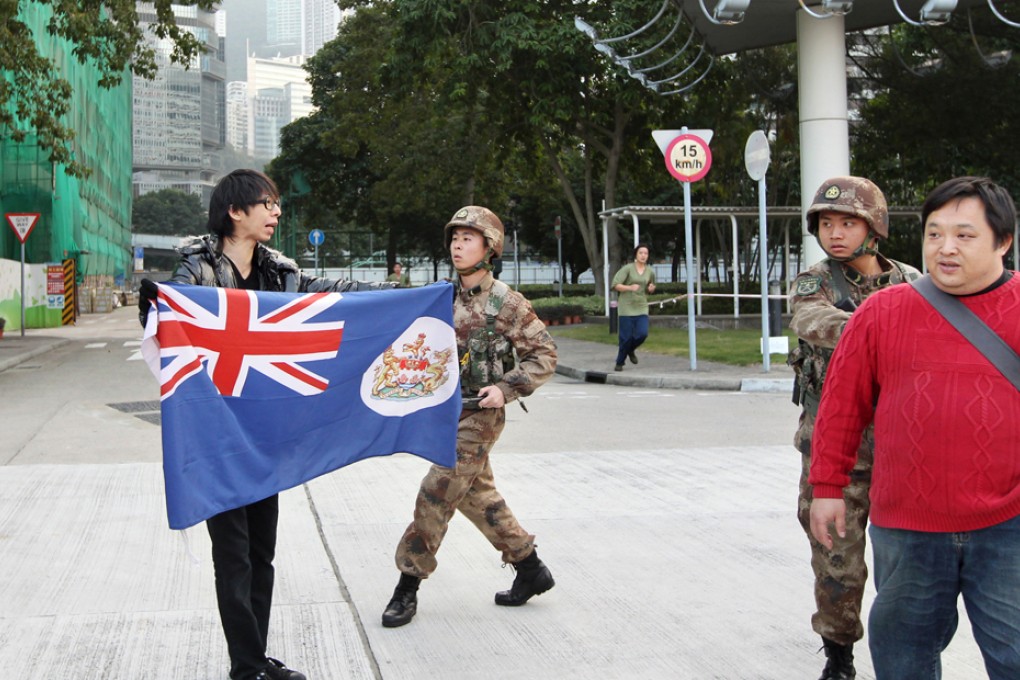 PLA soldiers stop protesters at the barracks. Photo: SCMP