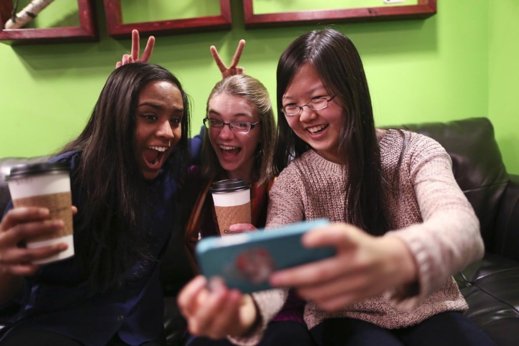 Friends take a Snapchat selfie, oblivious to risk. Photo: MCT