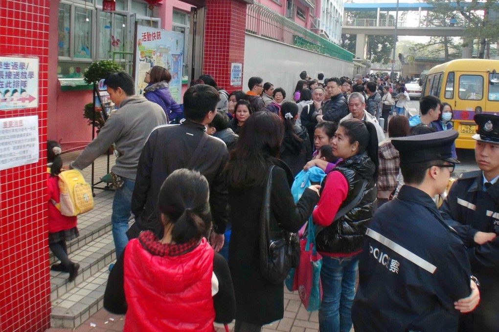 The queue for application forms stretches well beyond one Yuen Long kindergarten. Photo: SCMP