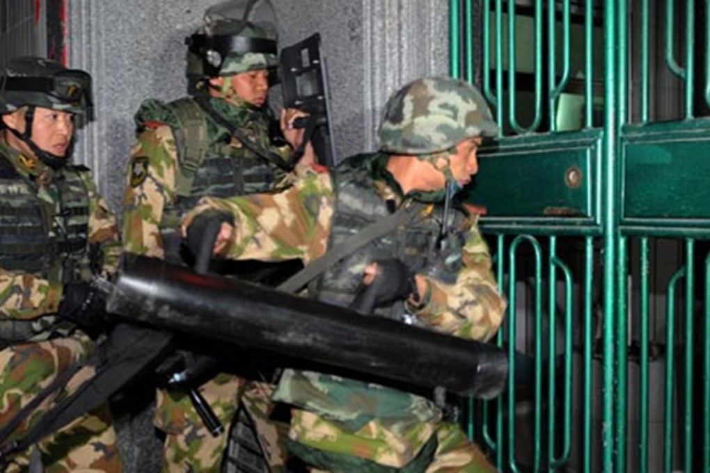 Police pictured during the raid in Boshe village, Lufeng city, Guangdong. Photo: SCMP/Handout