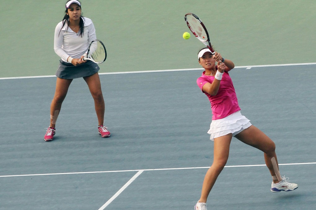 Hong Kong's Zhang Ling hits a return with her doubles partner Kazakhstan's Zarina Diyas looking on, at Victoria Park on Friday. Photo: Sam Tsang