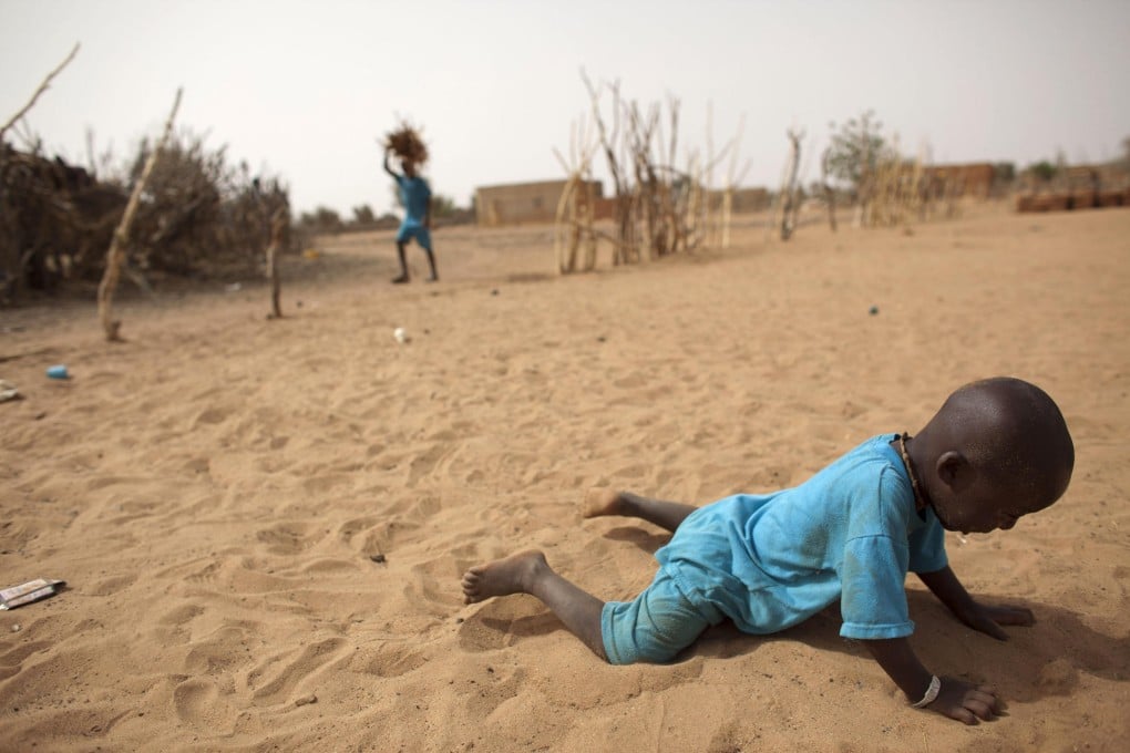 A toddler collapses in drought-stricken Senegal. Photo: AP
