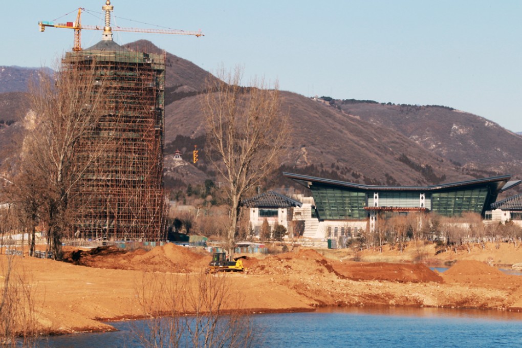 The main conference hall (right) and the observation tower of the Yanqihu (Yanqi Lake) Conference Resort, are under construction. The conference resort will hold the APEC meeting in 2014. Photo: Simon Song