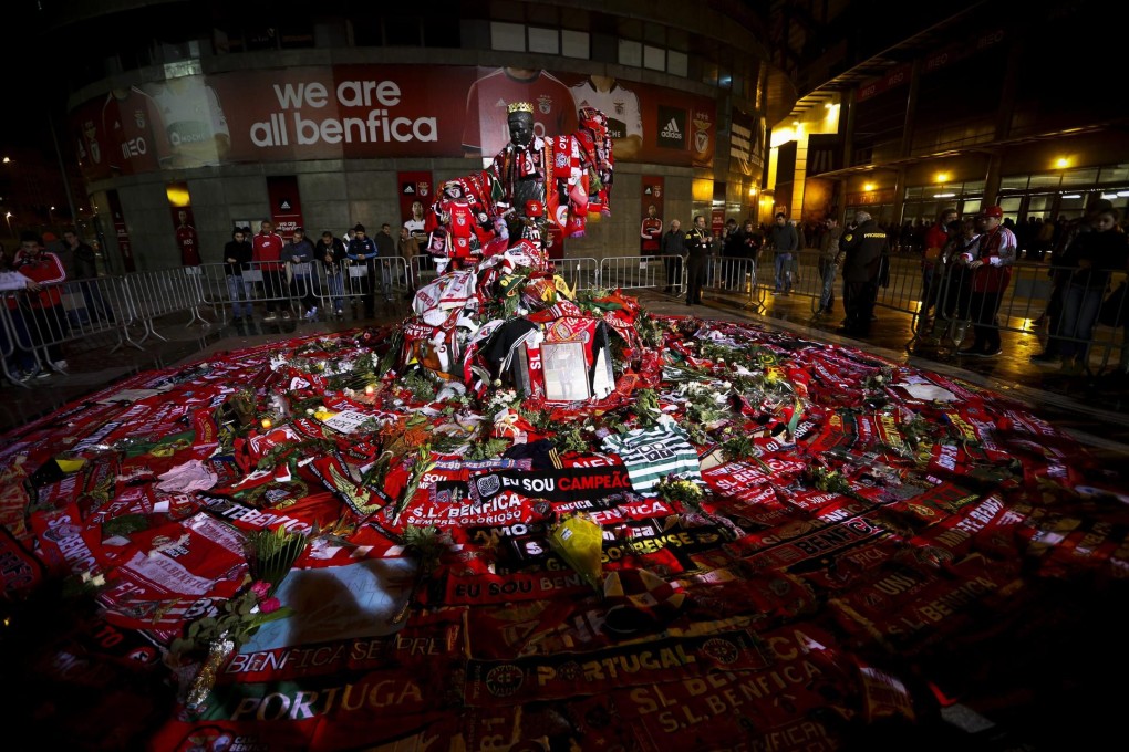 Scarves adorn a statue of Portugal soccer legend Eusebio in front of Benfica's Luz stadium in Lisbon on Monday. Photo: EPA