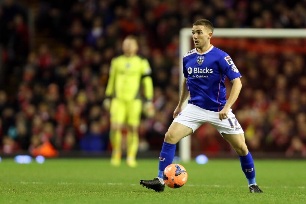 Oldham's Anton Rodgers plays against Liverpool - managed by his father Brendan - in the FA Cup at Anfield. Photo: AP
