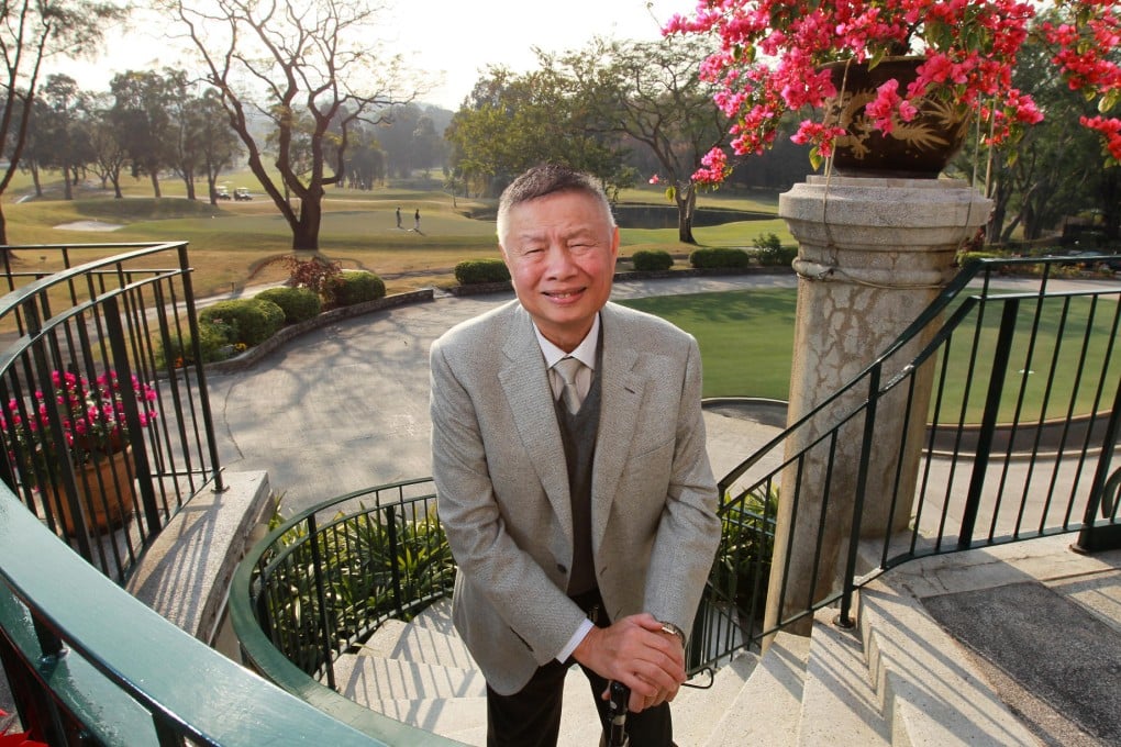 Marvin Cheung, president of the Hong Kong Golf Club, as, behind him, golfers finish off a game at the Fanling venue. Photo: Dickson Lee