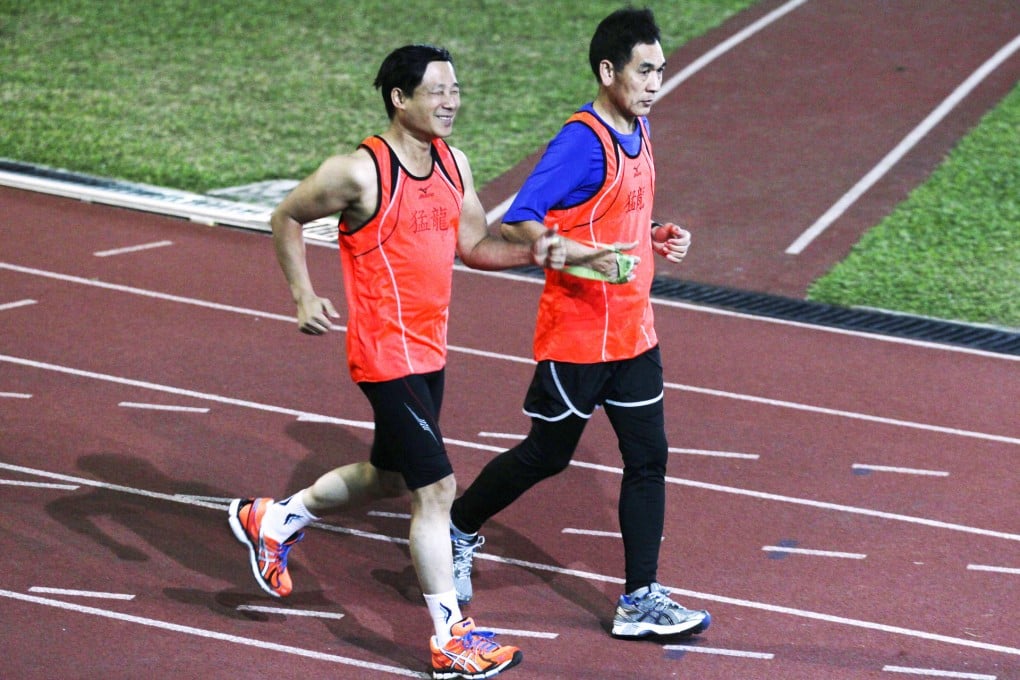 Visually impaired Mok Kim-wing and his deaf running partner Eric Yeung Yuk-wing training in Diamond Hill. Photo: Nora Tam