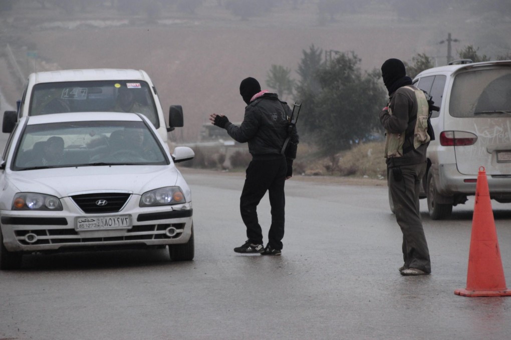 Free Syrian Army fighters man a checkpoint in Idlib to search for ISIL members. Photo: Reuters