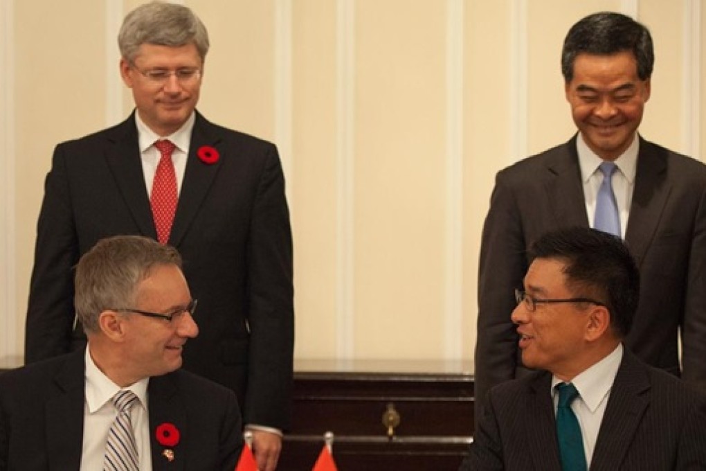 Canada’s Prime Minister Stephen Harper and Hong Kong Chief Executive Leung Chun-ying witness the signing of the HK-Canada tax treaty in November 2012 by ministers Ed Fast and KC Chan.  Credit: SCMP Pictures