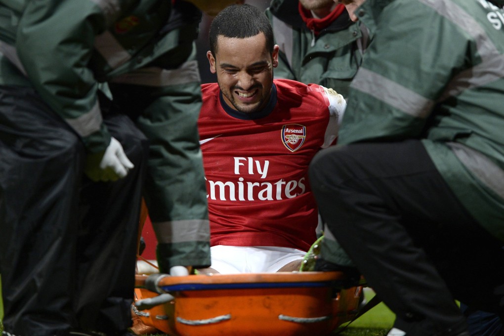 Arsenal and England forward Theo Walcott is stretchered off the field after injuring his knee against Tottenham last Saturday. Photo: Reuters