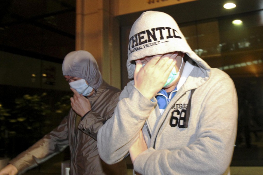 Two unidentified Happy Valley Football Club staff members leave the ICAC headquarters last night. Photo: SCMP