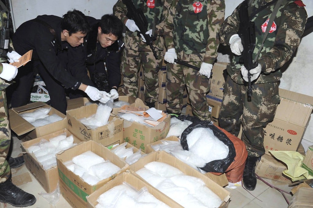 Police check seized crystal meth at Boshe village in Guangdong. Photo: Reuters