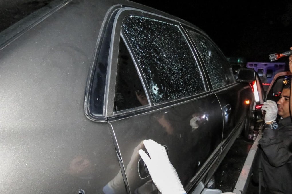 Forensic experts inspect the car in which former Miss Venezuela Monica Spear and her husband Thomas Berry were killed. Photo: EPA