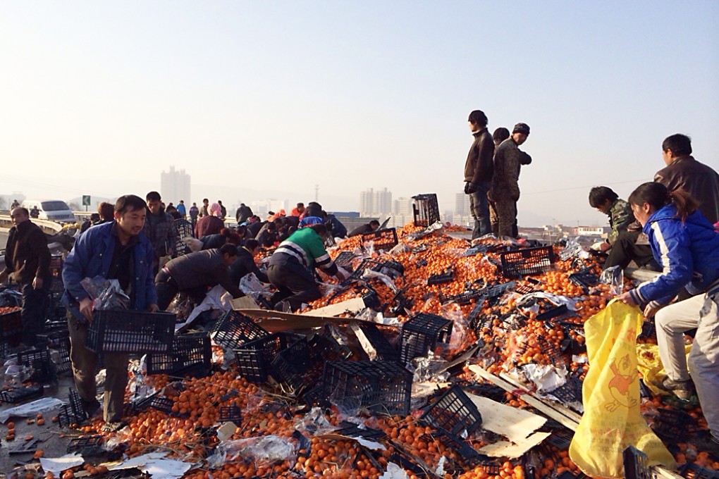 Villagers steal spilled oranges on a highway in this picture taken by an onlooker and uploaded to Weibo. Photo: Weibo Screenshot