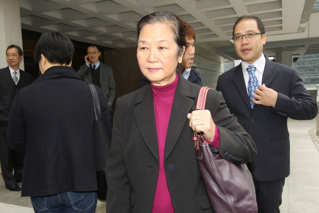 Leung Sui-kwan, wife of late Yung Kee restaurant shareholder Kam Kwan-sing, leaves the High Court with her son Hardy Kam Shun-yuen (right). Photo: Edward Wong