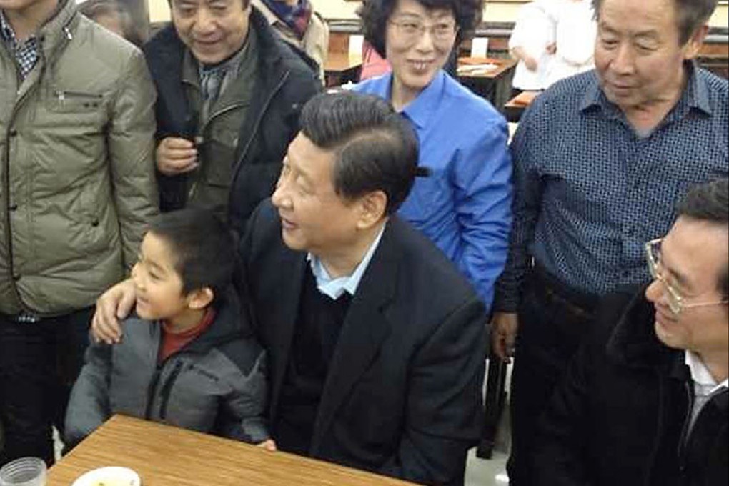 Chinese president Xi Jinping seen in a Beijing steamed bun restaurant taking a picture with a young boy on December 28, 2013. Photo: SCMP Pictures