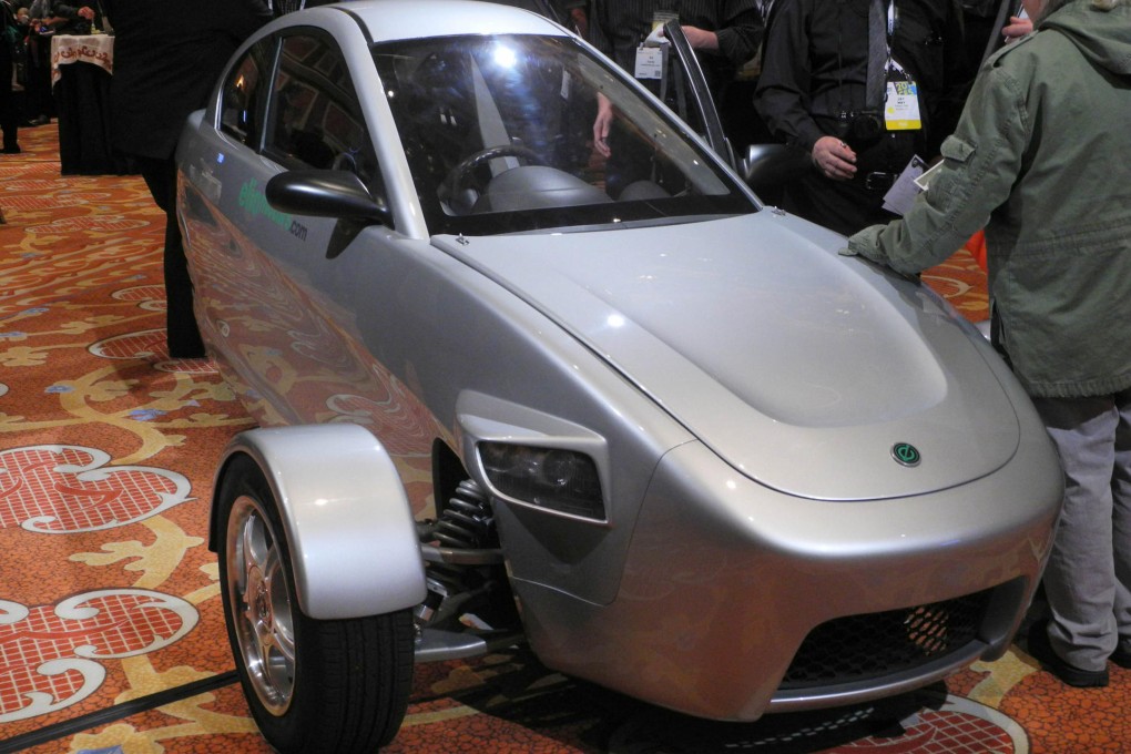 Visitors to ShowStoppers in Las Vegas check out a prototype of Elio's three-wheeled car. Photo: AFP