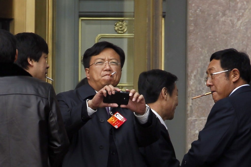 Chinese delegates attending a meeting at the Great Hall of the People in Beijing smoke cigarettes on March 4, 2012. Photo: Associated Press