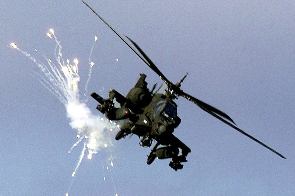 A US military Apache helicopter fires anti-missile flares. Photo: Reuters