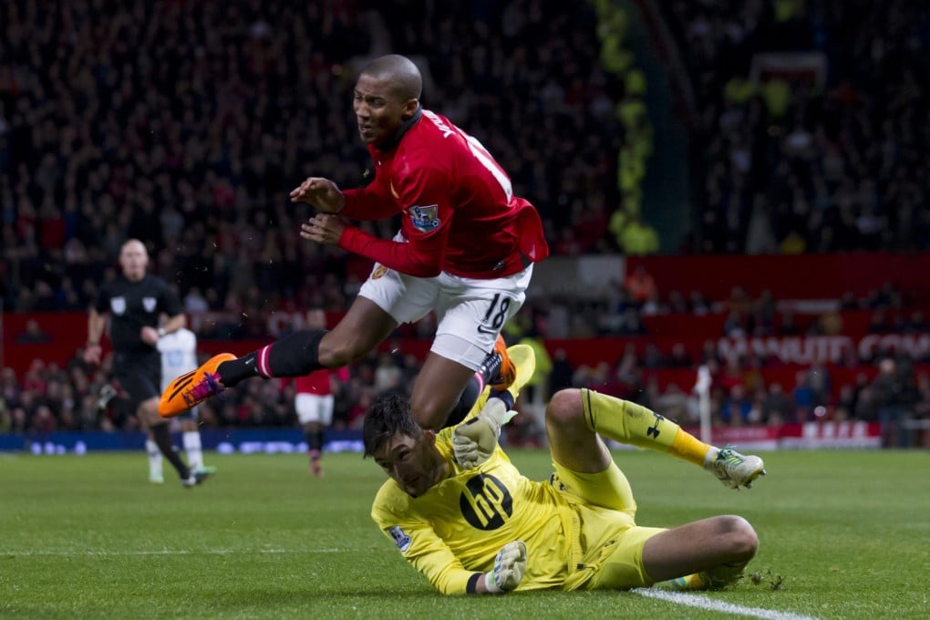 Manchester United's Ashley Young appears to be brought down by Tottenham's goalkeeper Hugo Lloris in their English Premier League soccer match at Old Trafford. Photo: AP