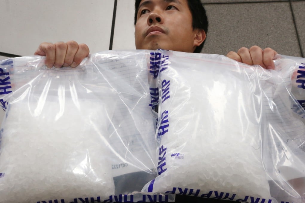 A police officer displays seized methamphetamine, commonly known as Ice.