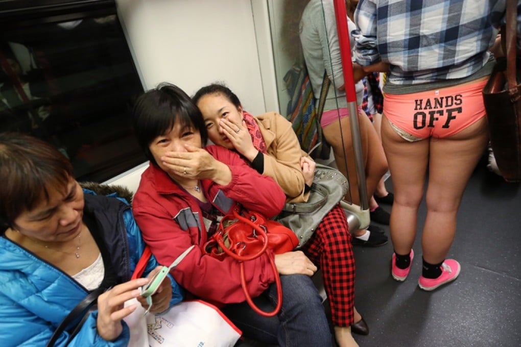 Giggling passengers don't know where to look as half-dressed passengers get on board. Photo: David Wong