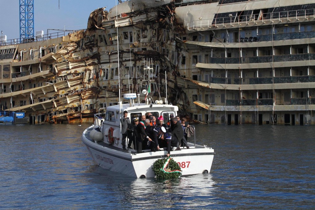 Naval personnel drop a wreath near the wreck of the liner Costa Concordia in the town of Giglio, in Northern Italy. Photo: EPA