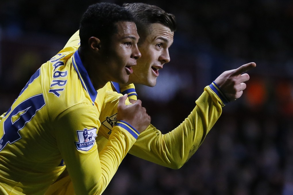 Arsenal's Jack Wilshere (right) celebrates with teammate Serge Gnabry after scoring against Aston Villa. Photo: AP