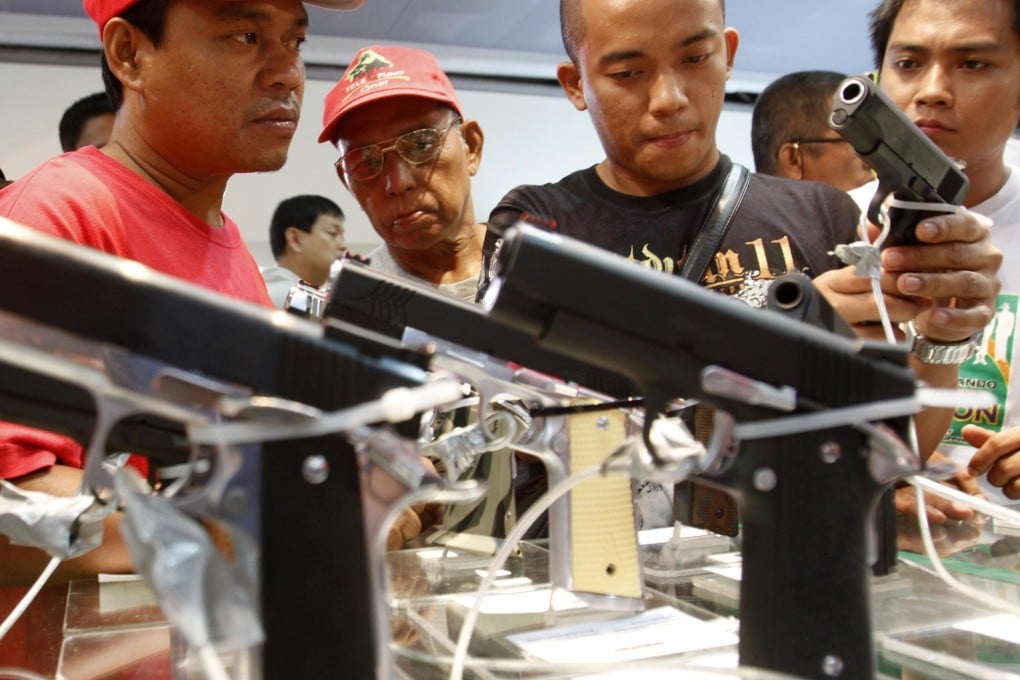 People look at the goods at a gun show in Manila in 2012. Photo: Reuters