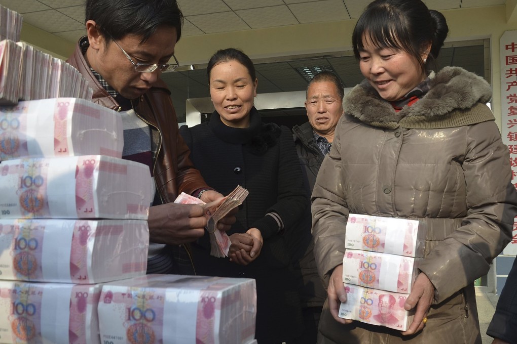 Ling Xuxia collects her 314,000 yuan year-end bonus at Jianshe village. Photo: Reuters
