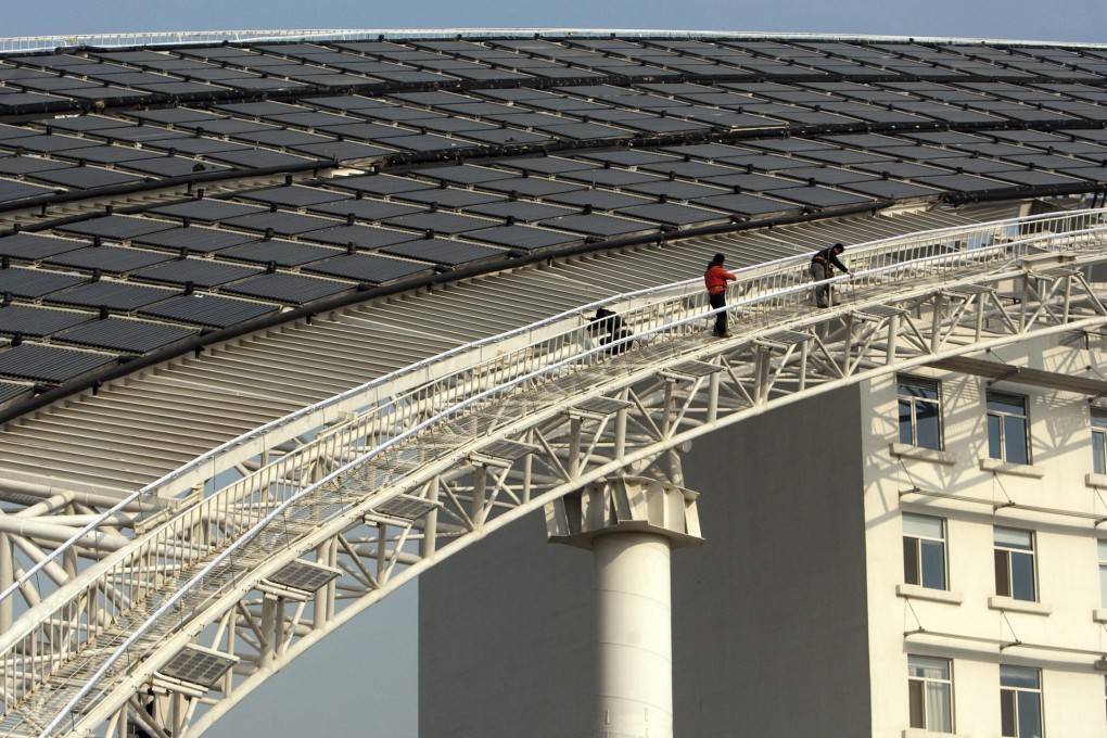 Workers carry out maintenance at the headquarters of solar water heater maker Himin Solar Energy Group in Shandong. Photo: Bloomberg