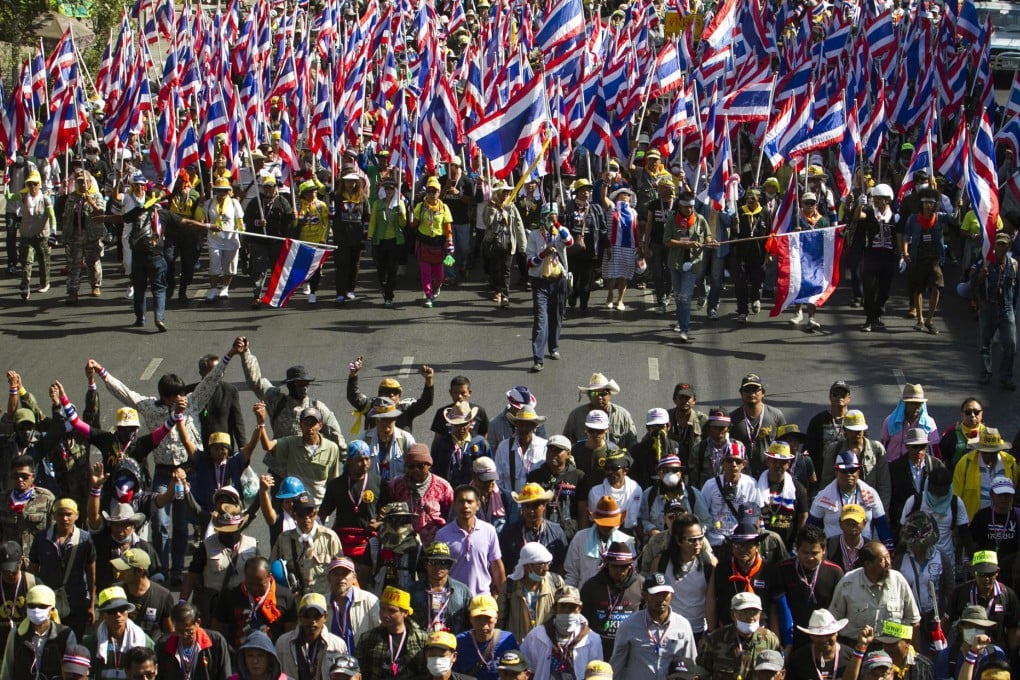 Protesters march yesterday in Bangkok as part of their efforts to paralyse the city and force Yingluck Shinawatra out of office. Photo: AP