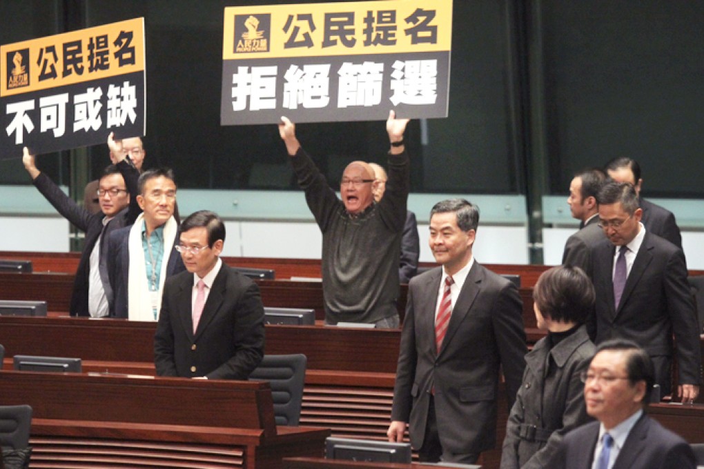 Lawmakers protest as the chief executive enters the Legco chamber to attend a question-and-answer session. Photo: Sam Tsang